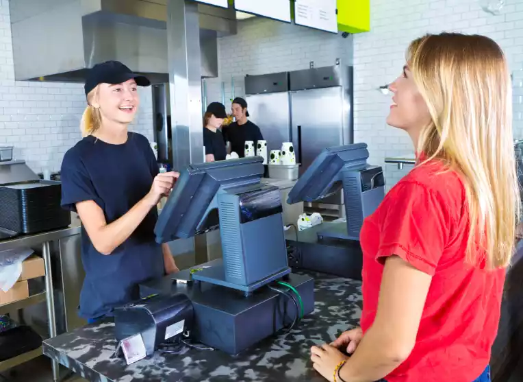 Restaurant staff member taking an order from a guest at the counter